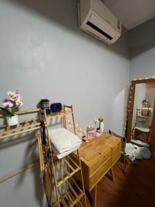 a room with a bunk bed with a fan and a table at แพนด้าแคมปิ้งเขาใหญ่ in Ban Khanong Phra Klang (1)