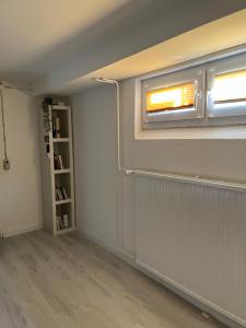 an empty room with a window and a book shelf at Ferienwohnung Fatlume No 1 in Bad Honnef am Rhein