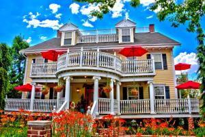 a house with two red umbrellas on top of it at Big Yellow Inn in Cedar City