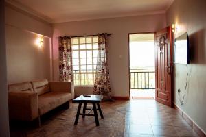 a living room with a couch and a table at Kitopua suites in Arusha