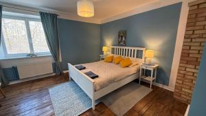 a bedroom with a bed with yellow pillows on it at Gaiziņstars in Bērzaune
