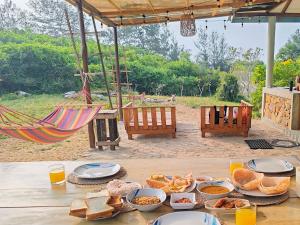 a table with food on it with a hammock at Garnet Yala Beach in Kirinda