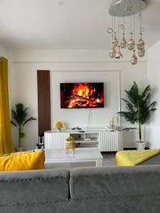 a living room with a couch and a fireplace at Bethany Cushy Home Ltd in Kisii