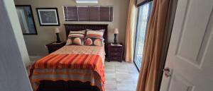 a bedroom with a bed with pillows and a window at Klaas Vakie Guesthouse in Beaufort West