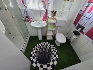 a small bathroom with a sink and a toilet and a sink at Klaas Vakie Guesthouse in Beaufort West