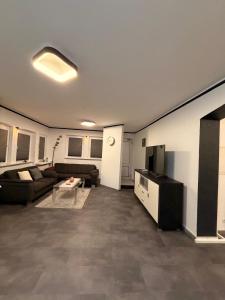 a living room with a couch and a tv at KM Apparts 2 Wesel in Wesel