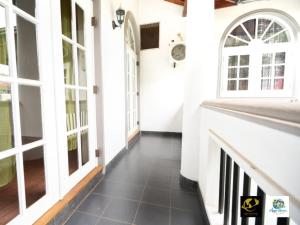 a hallway of a house with white walls and windows at Azure Heaven Villa in Wennappuwa