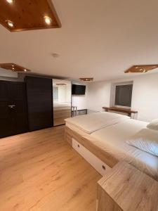 a large bedroom with a large bed and a television at KM Apparts 2 Wesel in Wesel