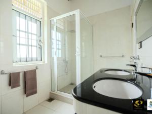 a bathroom with a sink and a shower at Azure Heaven Villa in Wennappuwa +27 photos