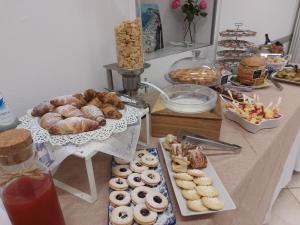 a table with a bunch of pastries and other foods at Villa Marcolini in Cattolica +22 photos