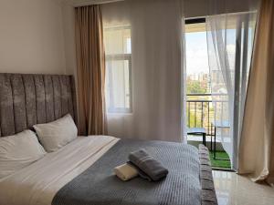 a bedroom with a bed and a window with a view at The Royal Retreat in Ruaka +33 photos