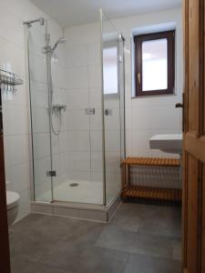a bathroom with a glass shower with a sink at Roubenka pod Čerťákem in Dolní Moravice +10 photos