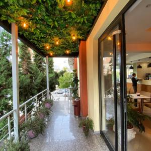 a balcony of a restaurant with a green ceiling at Selez Aparthotel & Residence in Durrës