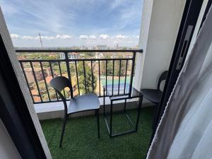 a balcony with two chairs and a table and a view at The Royal Retreat in Ruaka