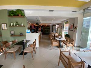 a dining room with tables and chairs in a restaurant at Selez Aparthotel & Residence in Durrës