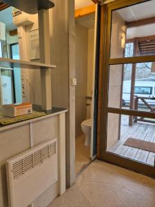 a door leading into a bathroom with a toilet at Bungalows Prados Abiertos in Mombeltrán +7 photos