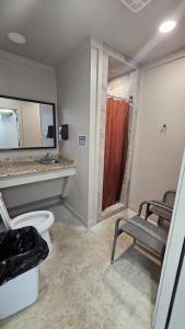 a bathroom with a toilet and a sink and a shower at Starry Skies RV in Victoria