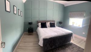 a bedroom with a bed with white sheets and pillows at Clontrain Cottage in Carrickmacross