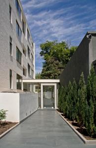 an external view of a building with a walkway at Heidelberg Haus Apart Hotel in Santiago