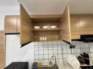 a kitchen with wooden cabinets and a sink at The Royal Retreat in Ruaka