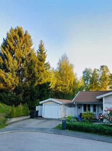 a house with a driveway in front of a house at Mini Hus in Märsta