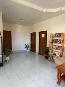 a lobby with a room with doors and a tiled floor at Secret Lanta Guesthouse in Ko Lanta