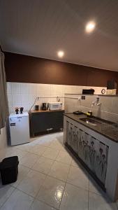 a kitchen with a stove and a refrigerator in it at Casa do João in Maricá +47 photos