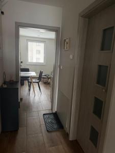 a hallway with a door leading to a dining room at Apartmán LUNA Choceň in Choceň +1 photo
