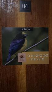 a book with a picture of a bird on a branch at Casa do João in Maricá