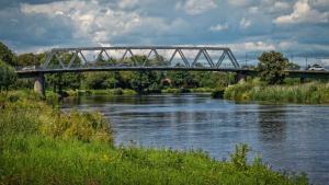 a bridge over a river with a train on it at Hagen`s Hotel "eat & meet" Restaurant Bar Lounge in Haren