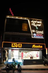 a store with a sign on the side of a building at SR Grand in Tumkūr