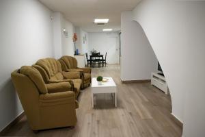 a living room with two chairs and a table at Suites TDJ Centro in Torredonjimeno