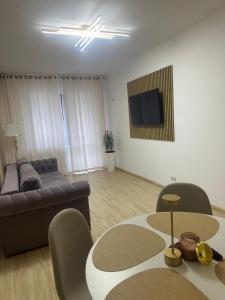 a living room with a couch and a table at Alex MNL lux Apartment 2 free parking in Bucharest +50 photos