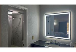 a bathroom with a sink and a mirror at Studio 6 Spindale, NC Forest City in Spindale +24 photos