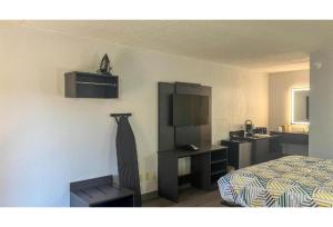 a hotel room with a bed and a sink at Studio 6 Spindale, NC Forest City in Spindale