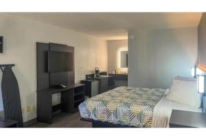a hotel room with a bed and a sink at Studio 6 Spindale, NC Forest City in Spindale