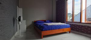 a small bed in a room with a window at Toraja Hikari Homestay in Rantepao