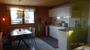 a small kitchen with a table and a window at Ferienwohnung Schlemmer in Doren