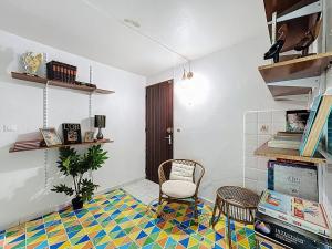 a living room with a chair and a tile floor at Uta Houses in Baie-Mahault