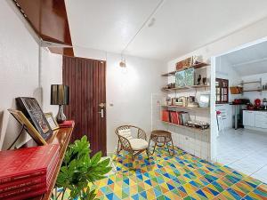 a living room with a table and a chair at Uta Houses in Baie-Mahault