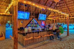a bar in a resort with people playing a game at Penthouse Water View in Puerto Peñasco +22 photos