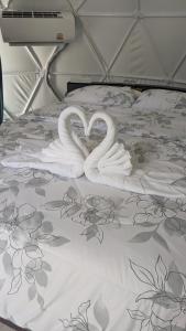 two white swans making a heart on a bed at Sunshine's Hill in Ko Lanta
