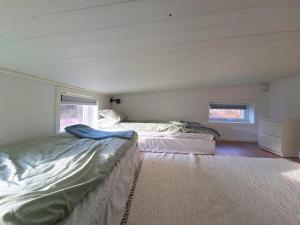 a bedroom with two beds in a room at Nybyggd loftstuga i centrala Grebbestad in Grebbestad