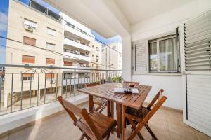a dining room with a table and chairs and a balcony at 2 bedroom flat in Strovolos