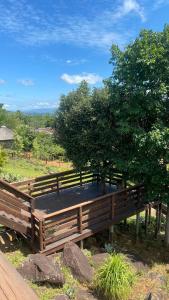 a wooden bench with a tree on top of it at Banabaka spa and venue in White River