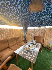 a room with a couch and a table with food on it at Dar Bennis médina in Rabat +66 photos