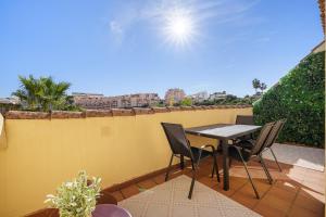 a patio with a table and chairs on a balcony at Duquesa Sea & Sun in Manilva