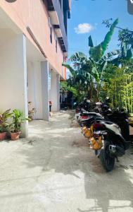 a row of motorcycles parked next to a building at Casa Dwayne room 102 in Cebu City