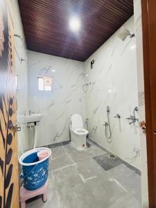 a bathroom with a toilet and a sink and a shower at Tunga sadan in Mādhavaram