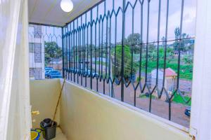a balcony with a window with a view of a park at GILGAL Homes in Kisii